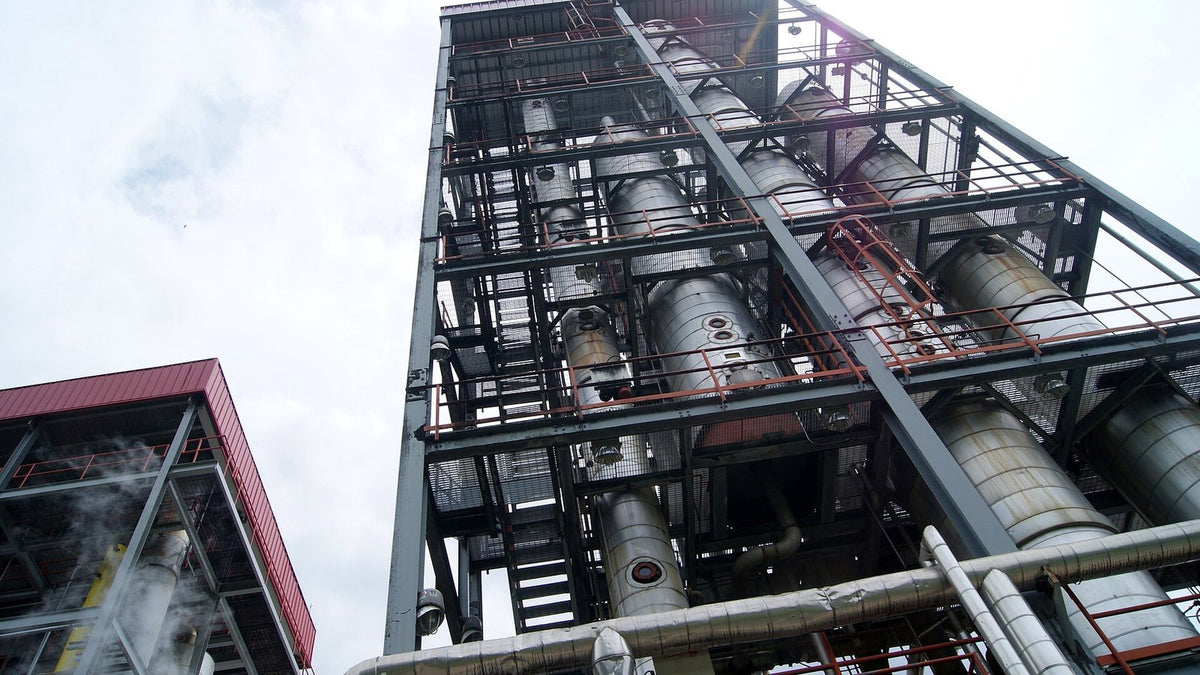 Looking up at a tall steel multi-column still at the Angostura distillery in Trinidad.