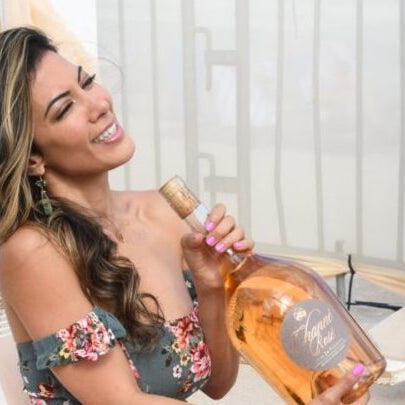 Two bottles of channe rosé resting in the sand on the beach