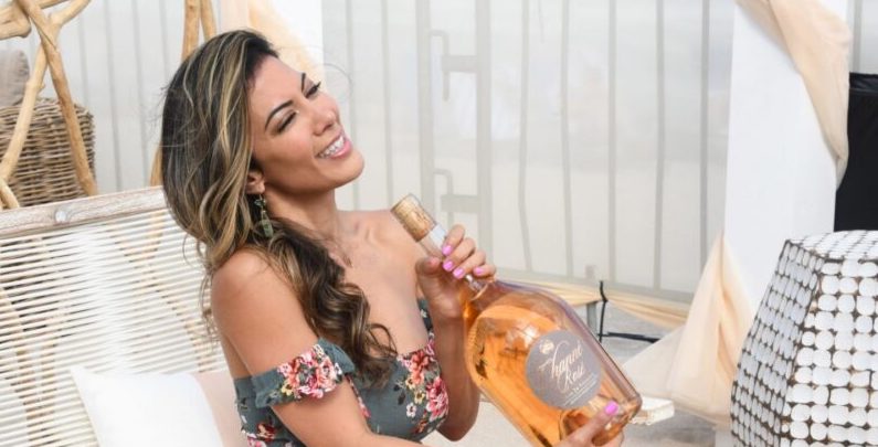 Two bottles of channe rosé resting in the sand on the beach