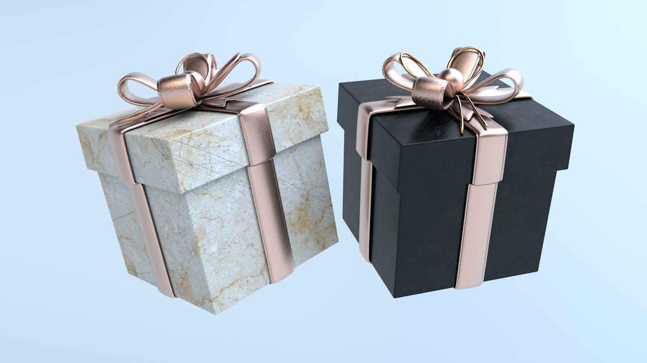 Elegant gift boxes finished with gold ribbon bows for corporate gifting