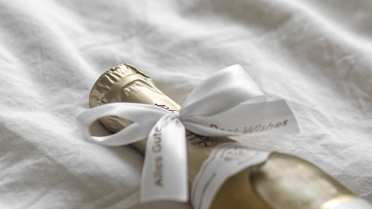 Champagne bottle tied with an elegant white ribbon